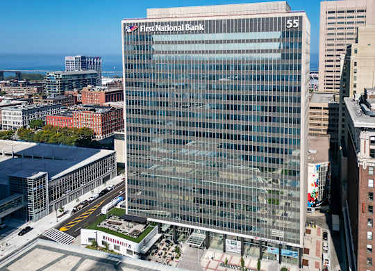 A tall glass building with the words