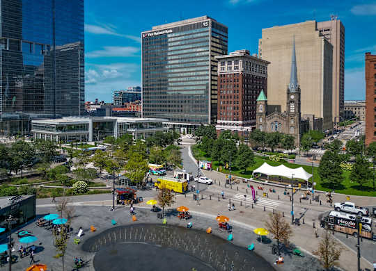 A cityscape with a large fountain in the center.