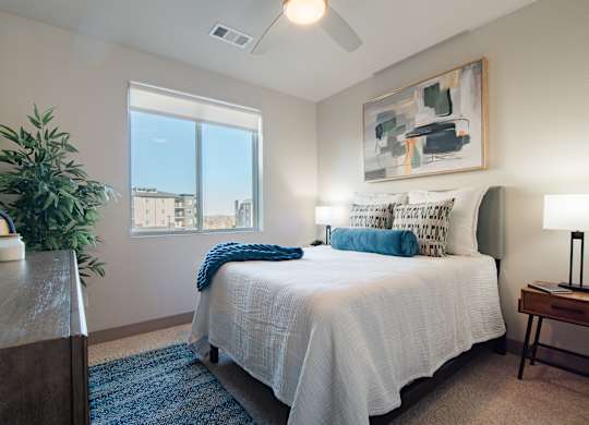 a bedroom with a large bed and a window at Parkside at Littleton Village, Littleton, CO