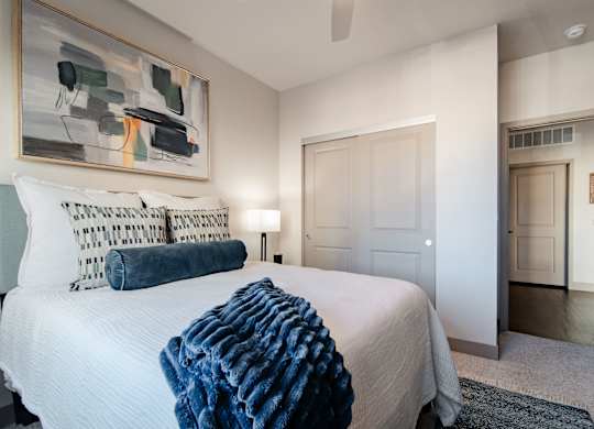a bedroom with a large bed and a painting on the wall at Parkside at Littleton Village, Littleton, CO