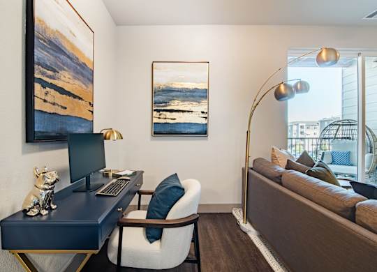 a living room with a desk with a computer and a couch at Parkside at Littleton Village, Littleton, CO