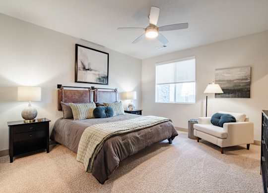 an empty bedroom with a bed and a ceiling fan at Parkside at Littleton Village, Littleton, Colorado