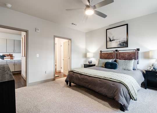a bedroom with a large bed and a ceiling fan at Parkside at Littleton Village, Littleton