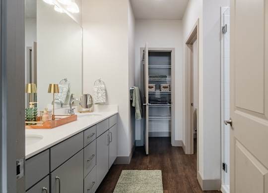 a bathroom with a sink and a mirror and a closet at Parkside at Littleton Village, Littleton, CO