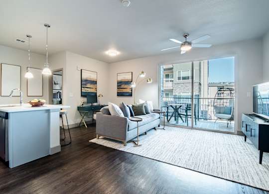 a living room with a couch and a kitchen at Parkside at Littleton Village, Littleton, CO