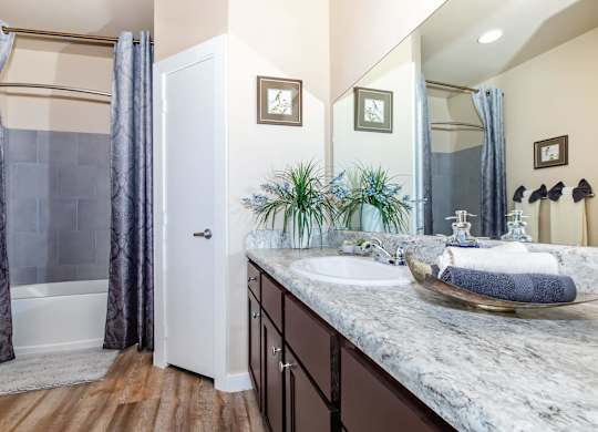A bathroom with a marble countertop and a white door.