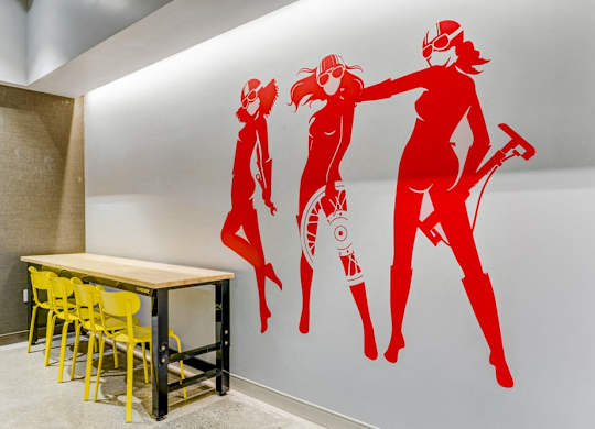 A wall with a red graphic of two women.