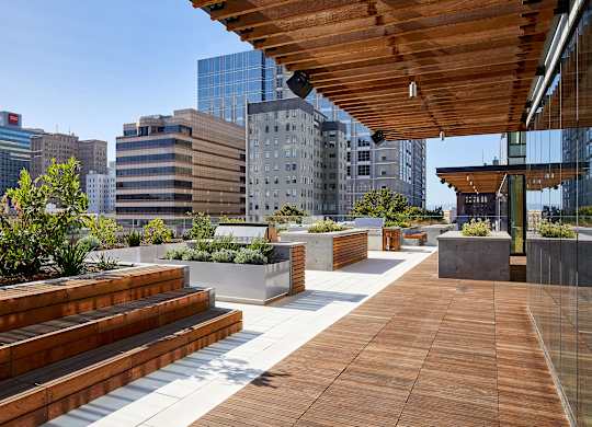 A wooden deck with steps and a metal railing.