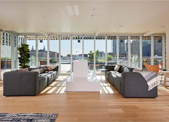 Lobby with two grey couches and a white table.