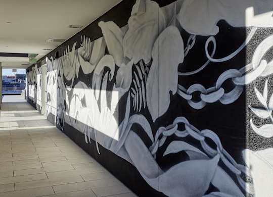 A long hallway with a black and white mural on the wall.