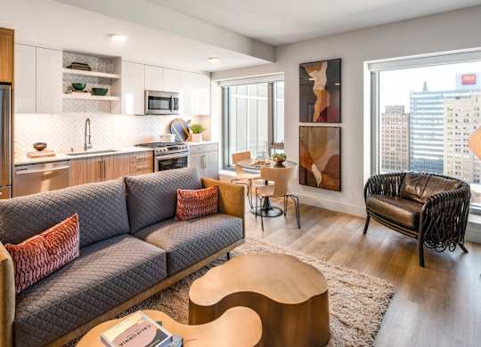 A modern living room with a grey sofa and a wooden coffee table.