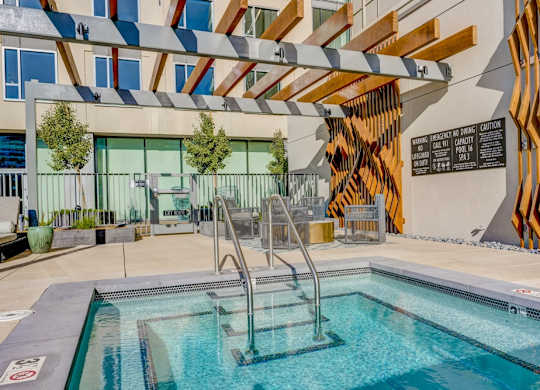 A pool with a slide and a sign that says