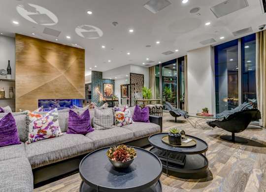 A modern living room with a grey sofa and a black coffee table.
