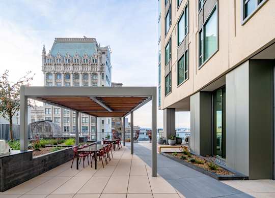 A modern building with a patio and a bench.