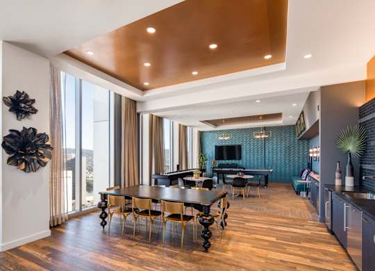 A modern dining room with a wooden table and chairs.