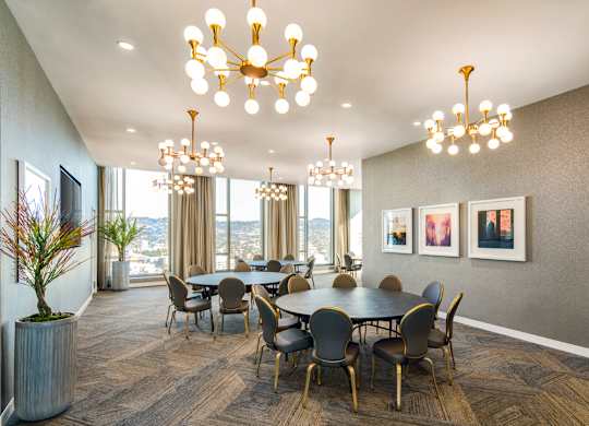 A dining room with a large table and chairs.