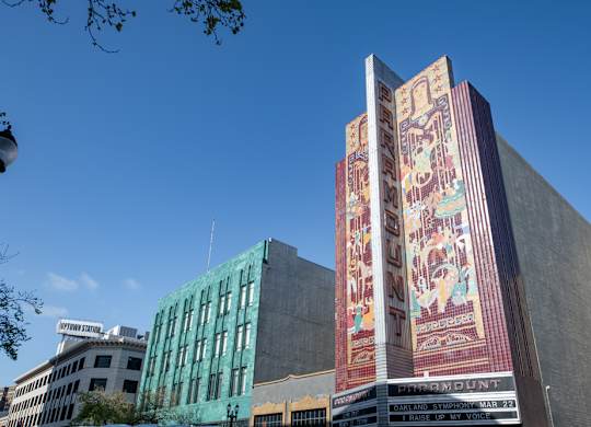 A tall building with a mural on the side of it.