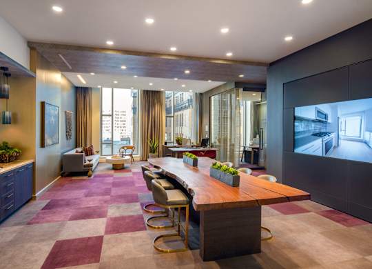 A conference room with a long table and chairs.