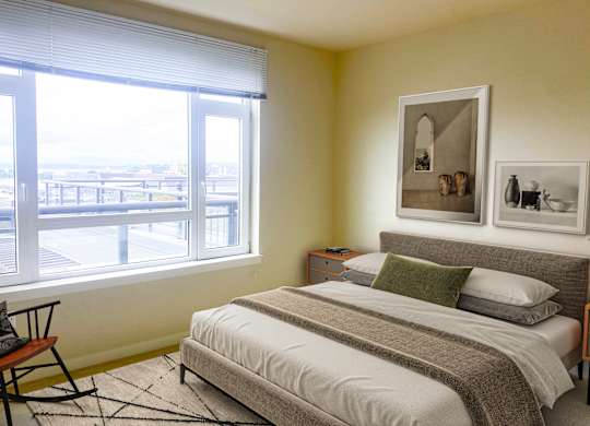 Bright bedroom with city view balcony at Axis Seattle Apartments, Seattle