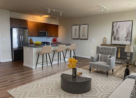 Open concept living room and kitchen area at Axis Seattle Apartments, Washington