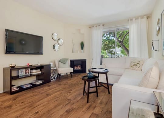 A living room with a fireplace and a television.at Norwalk Metropointe, Norwalk  