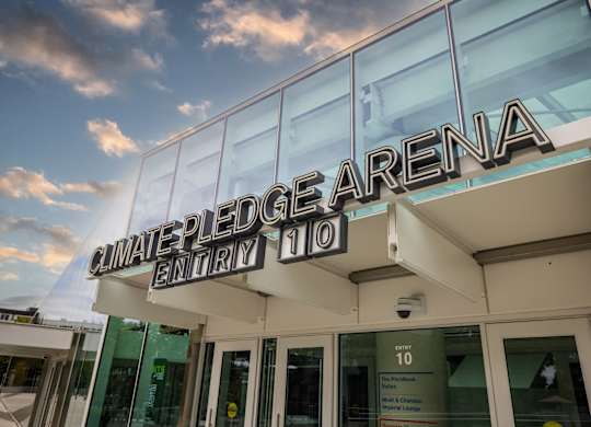 Climate pledge arena entrance signage with glass facade at Axis Seattle Apartments, Washington, 98109