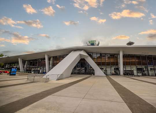 Modern arena with curved architectural entrance at Axis Seattle Apartments, Seattle, WA 98109