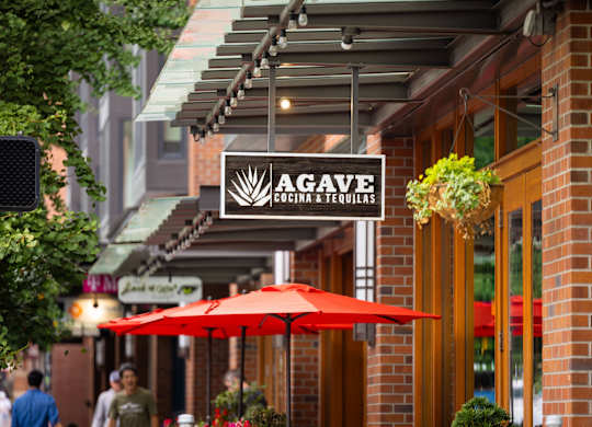 Restaurant storefront with outdoor patio umbrellas at Axis Seattle Apartments, Seattle, 98109