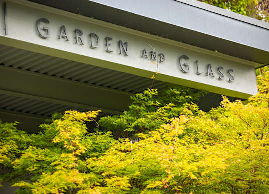 Garden and glass sign with vibrant foliage at Axis Seattle Apartments, Washington