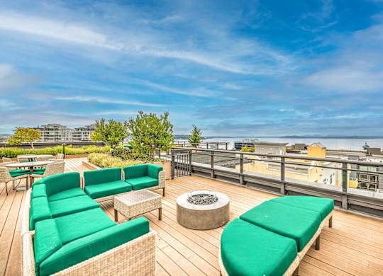Rooftop deck with fire pit and waterfront views at Axis Seattle Apartments, Seattle, WA 98109