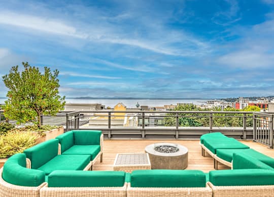 Rooftop deck with fire pit and green lounge seating at Axis Seattle Apartments, Seattle, WA
