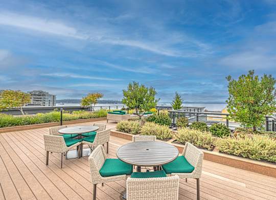 Rooftop terrace with dining tables and garden beds at Axis Seattle Apartments, Seattle
