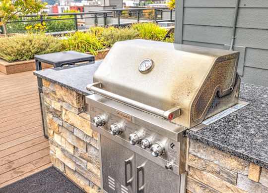 Built in outdoor grill with stone island surround at Axis Seattle Apartments, Washington, 98109