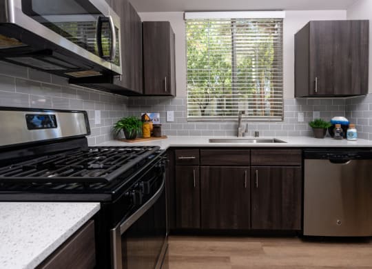 a kitchen with stainless steel appliances and wooden cabinets