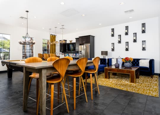a dining area with a table and chairs and a living room with a television