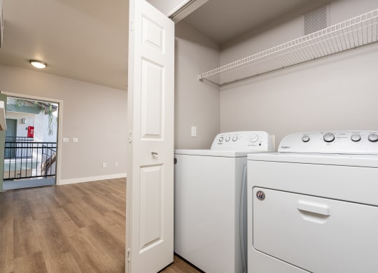 the laundry room of a house with a washer and dryer