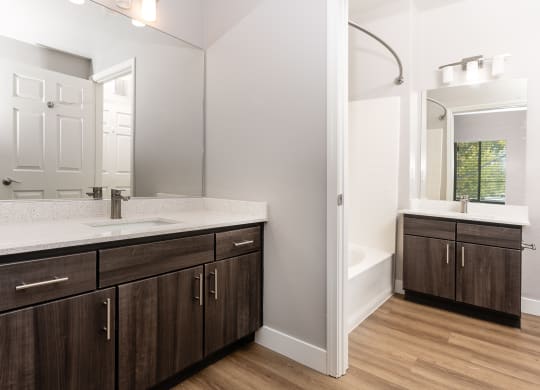 a bathroom with wooden cabinets and a sink and a mirror