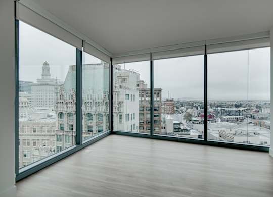 A large empty room with a view of the city.
