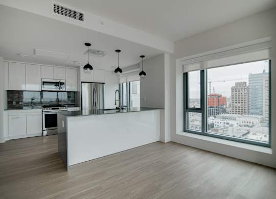 A modern kitchen with a view of the city.