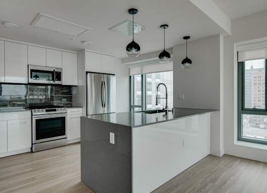 A modern kitchen with a large island in the center.
