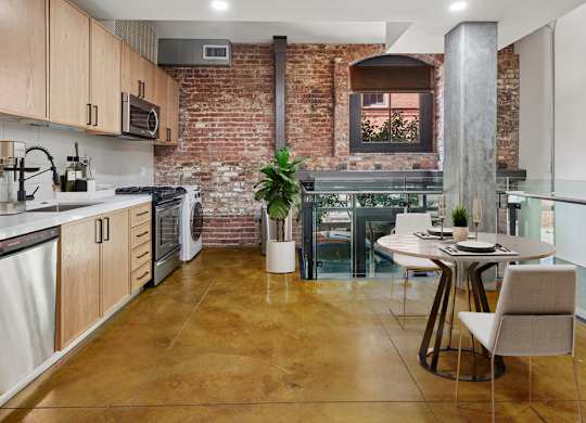 A kitchen with a table and chairs in the middle of the room.