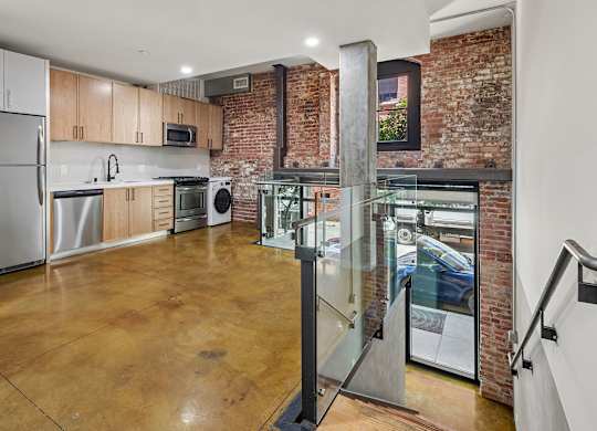 A kitchen with a refrigerator, microwave, oven, and dishwasher.