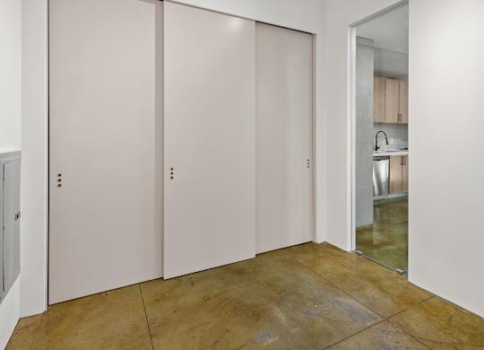 Three white doors in a room.