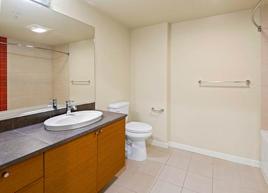 Spacious bathroom with tub and modern vanity at Axis Seattle Apartments, Washington