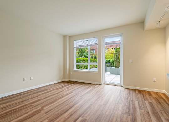 Spacious living room with patio access at Axis Seattle Apartments, Seattle, WA 98109