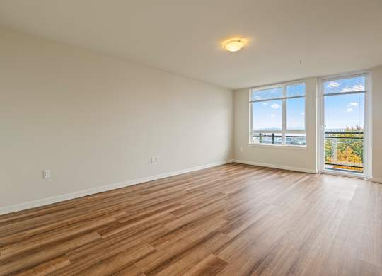 Bright empty room with laminate flooring and windows at Axis Seattle Apartments, Seattle