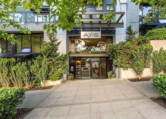 Property entrance with modern canopy and landscaping at Axis Seattle Apartments, Seattle