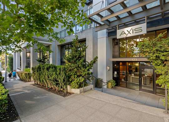 Modern building entrance with landscaping and signage at Axis Seattle Apartments, Washington