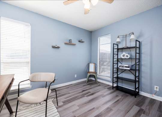 A room with a blue wall and a wooden floor.
