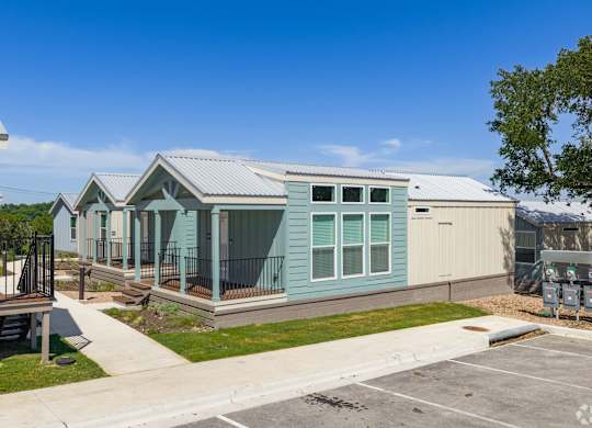 A row of houses with a clear blue sky above them.